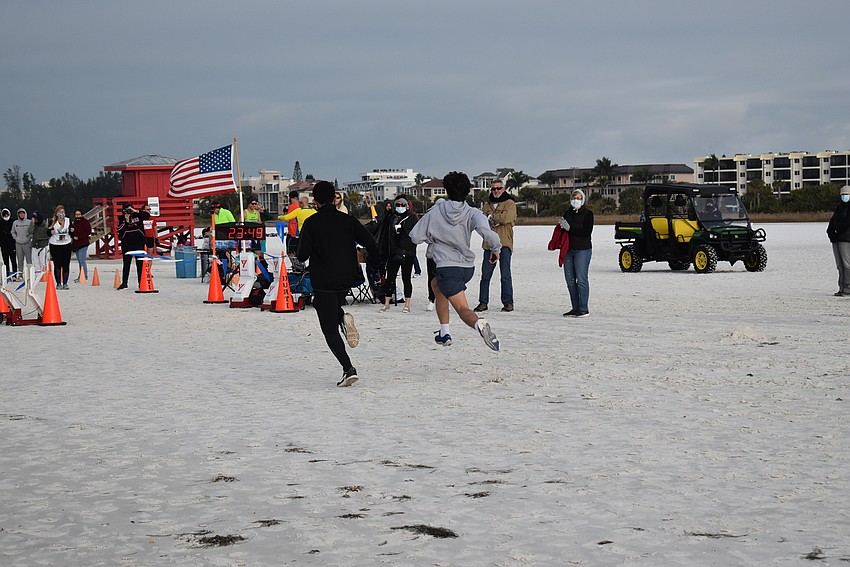 Two runners sprint for a photo finish.
