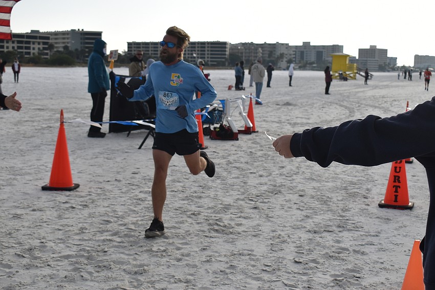 Tom Mitchell finishes third.