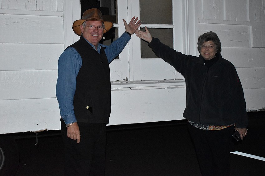 Longboat Key Historical Society President Michael Drake and Treasurer Cathy Meldahl pose for a picture next to the historic cottage.