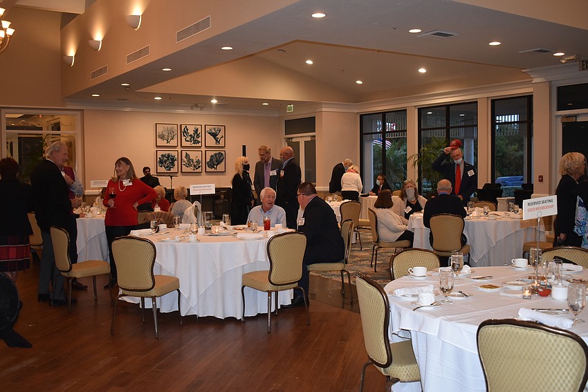 Members claimed spots at tables, but mingled before dinner.