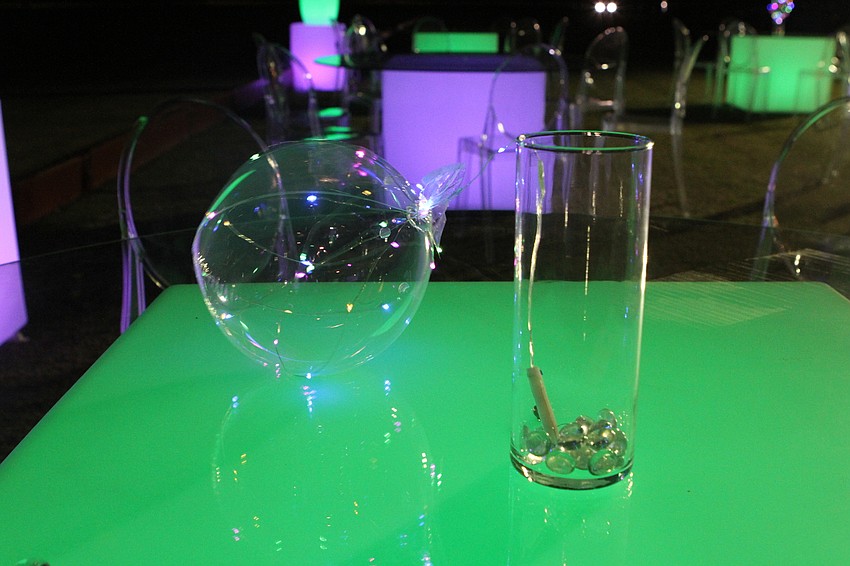 The event had outdoor seating and glow tables but rain sent everyone indoors.