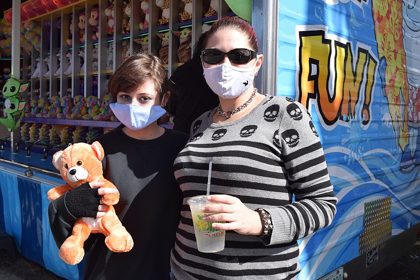 Palmetto's Jeremy Heere shows off the bear won after a squirt gun contest against Palmetto's Jenna Belle.