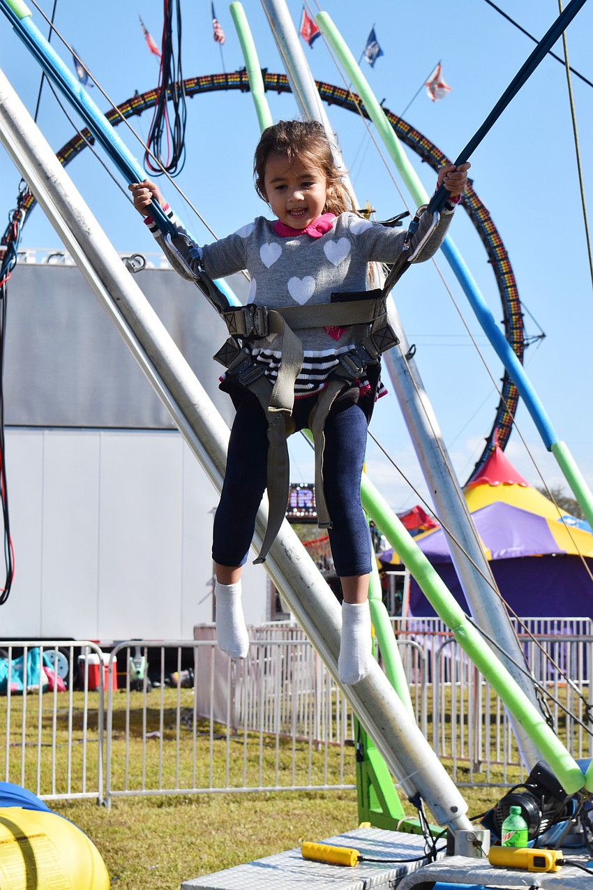 Ellenton's Lucy Teav, who is 4, jumps as high as she can on the trampoline.