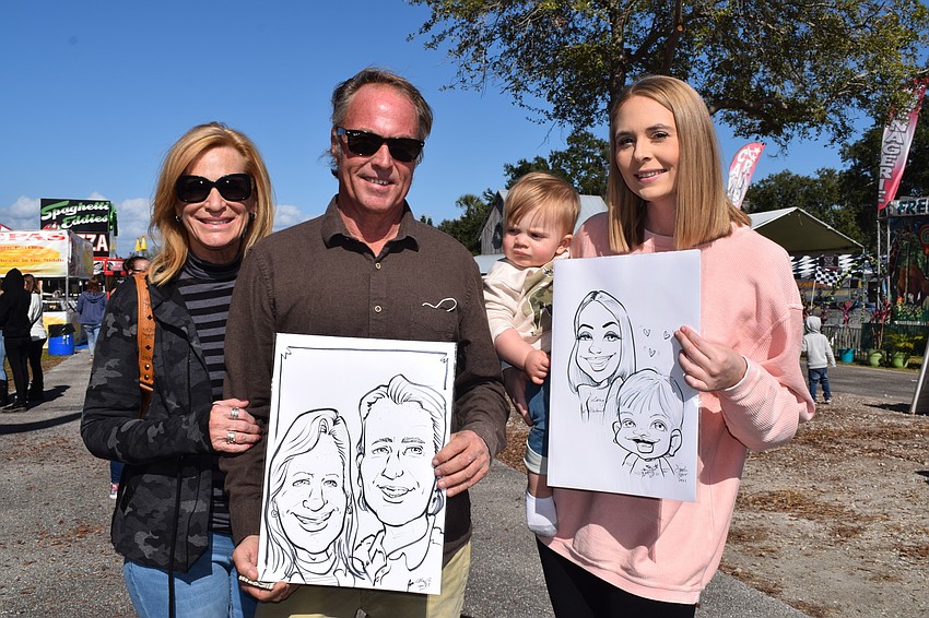 Holmes Beach's Kelly and Barry Moffatt and Bradenton's Michael Wood, who is 1, and Ryan Moffatt show off the caricatures they had done at the fair.