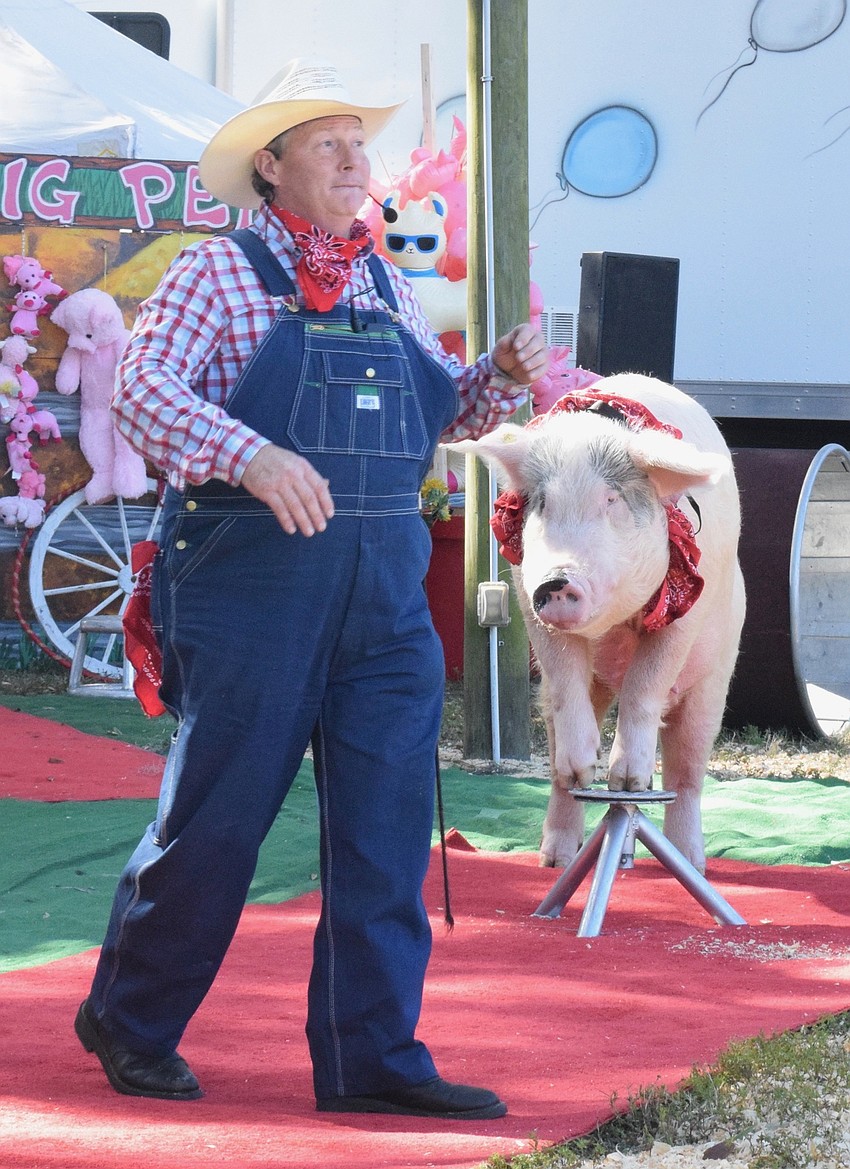 Les Kimes, owner of the Pork Chop Revue, introduces Mac the pig to the crowd.