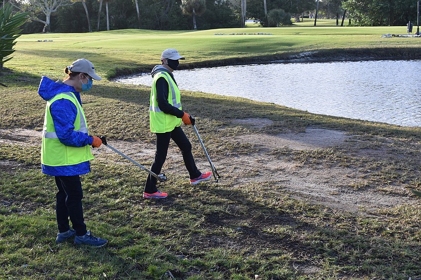 Jinx Kochan and Liz Sparr grabbed trash from near a water hazard on the Longboat Key Club golf course.