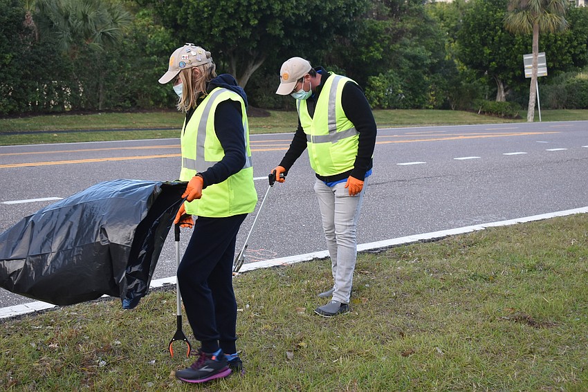 The club fought wind, which inflated trash bags held at the wrong angle and threatened to empty the trash out.