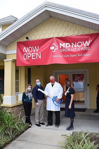 Caitlyn Haley and Tim Fenimore of the Manatee Chamber of Commerce, Dr. Brandon Coffey of MD Now and Carol Kolenda, district secretary for Rep. Tommy Gregory, prepare for the ribbon cutting.
