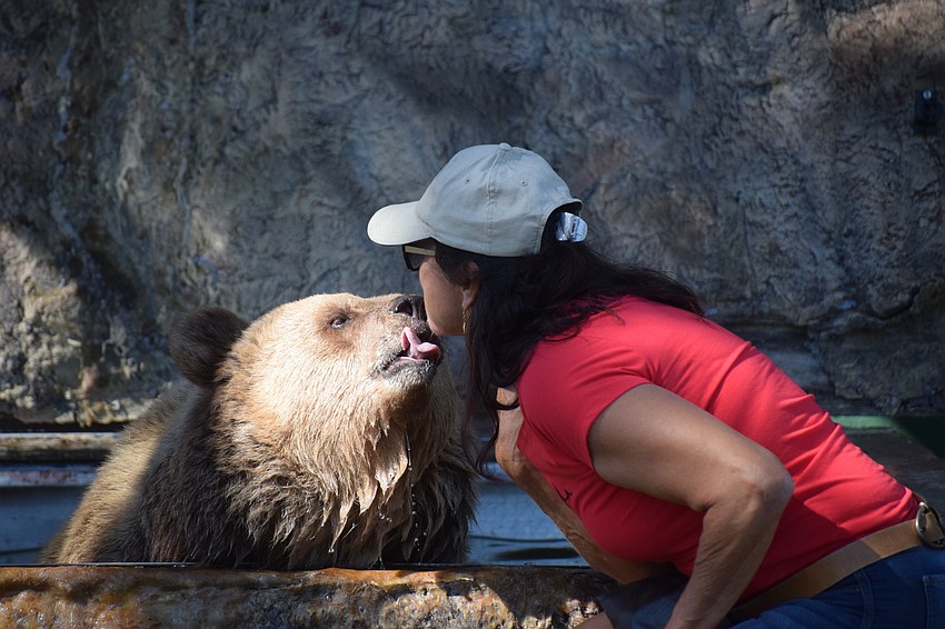 Carol takes a break from swimming to give Monica Welde a kiss.