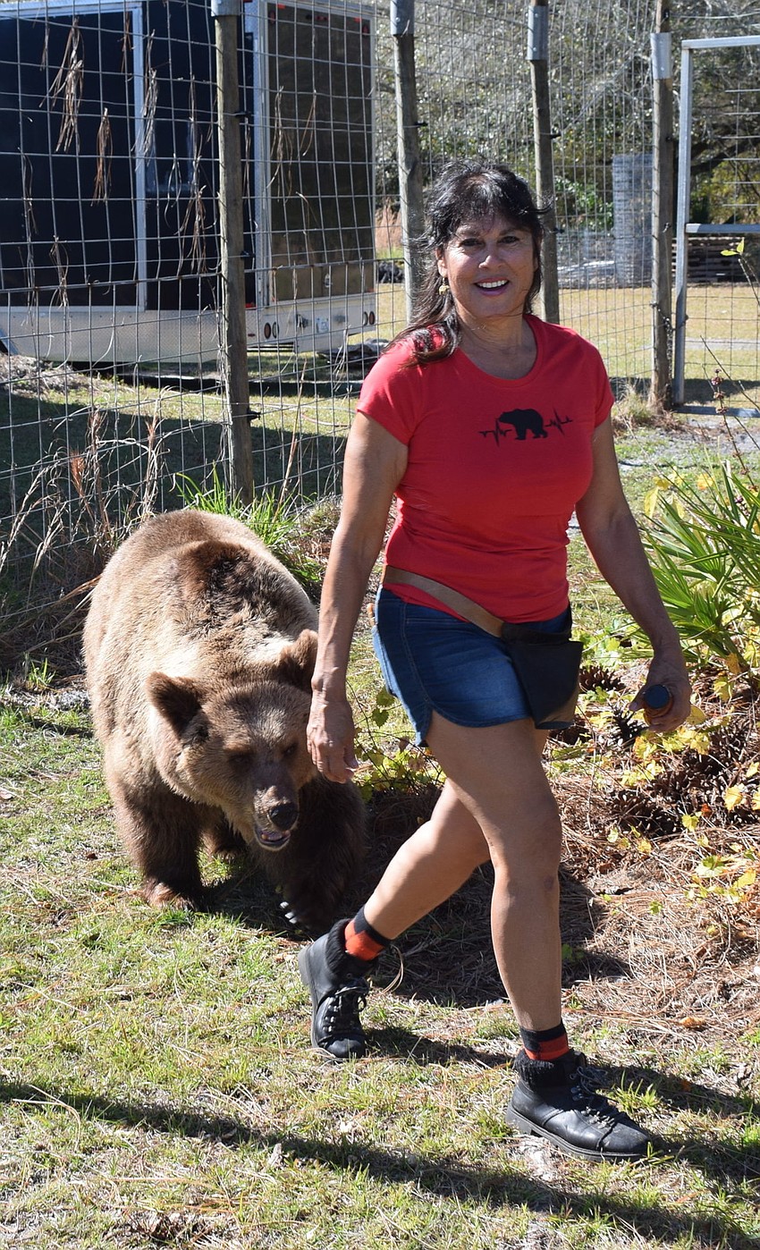 Carol follows Monica Welde around the habitat at Bearadise.