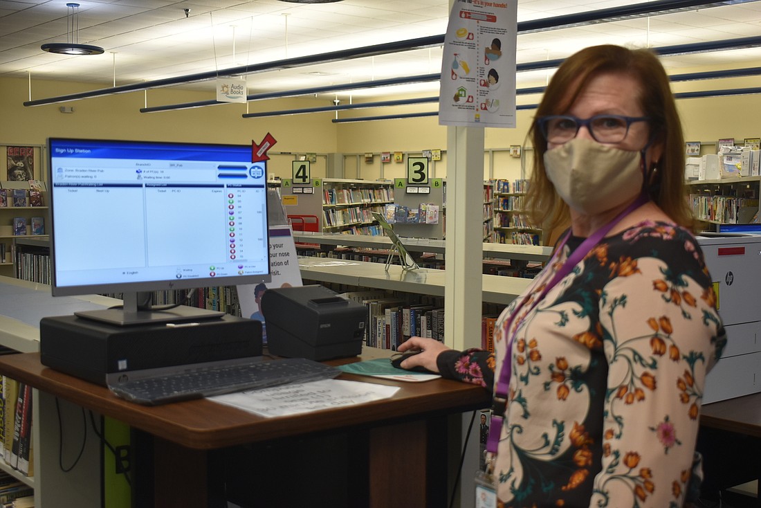 Braden River Library Assistant Supervisor Mary Frueh is one of many library staff members who have helped register seniors for the vaccine through library computer workstations.