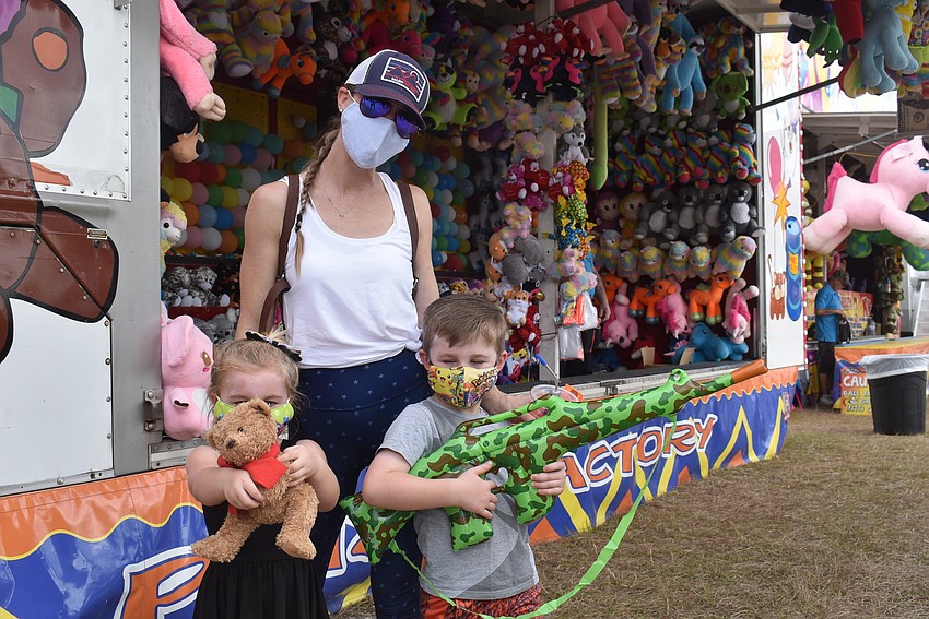 Rye Wilderness residents Aelish Carter, 3, Maeve Carter and Ronan Carter, 5, display prizes they won playing carnival games. Maeve's kids wanted to go to the carnival for the ferris wheel but decided they were too scared to ride.