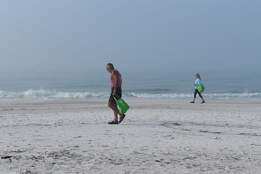 Tim Hellige and Lonna Smith spread out across the beach to make sure no trash went unpicked.