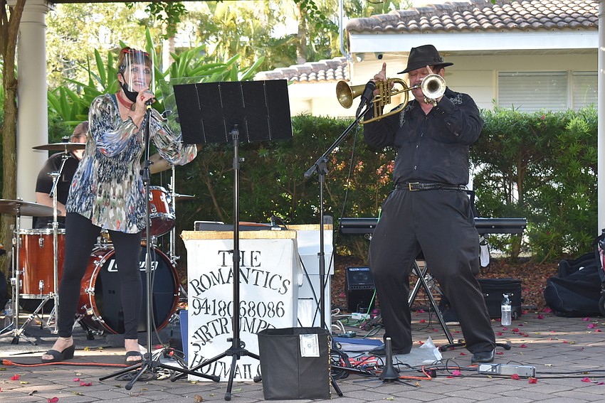 Cynthony Palmer sings while Steve Roiland plays two trumpets.