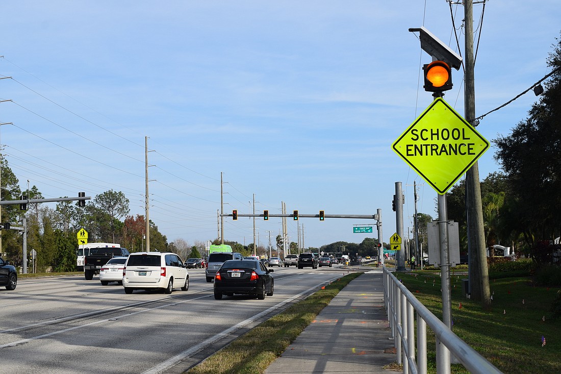 School zone signs have been replaced with school entrance signs, meaning cars no longer have to slow to 20 miles per hour when the yellow light flashes.