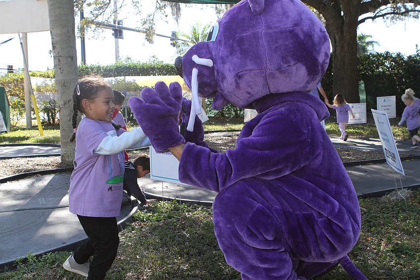 Annalise Gant high fives Menschy during the race.