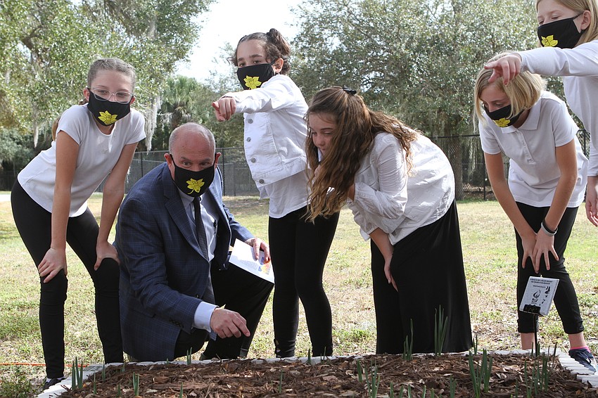 Elementary Education Executive Director Chris Renouf took a look at the garden with Gulf Gate students.