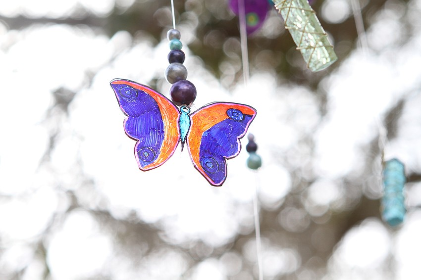 The garden has butterfly mobiles hanging overhead.