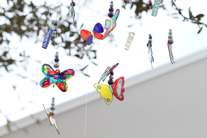 The garden has butterfly mobiles hanging overhead.