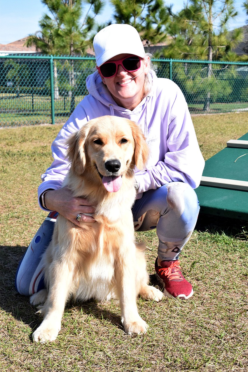 Lakewood Ranch's Connie Farmer continues to train her golden retriever, Bella, during the Doggy Bootcamp Agility Class.