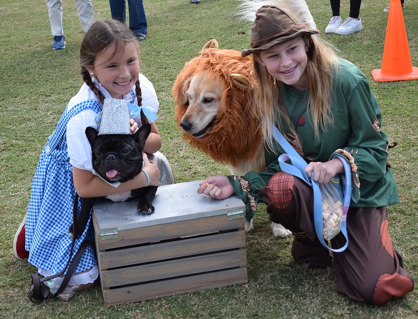 Sarasota's Olivia Pundy, as Dorothy holds Willie, who is dressed as the Tin Man, while Lily plays the Cowardly Lion and Sarasota's Kate Daoust plays the Scarecrow. They won Best in Show.