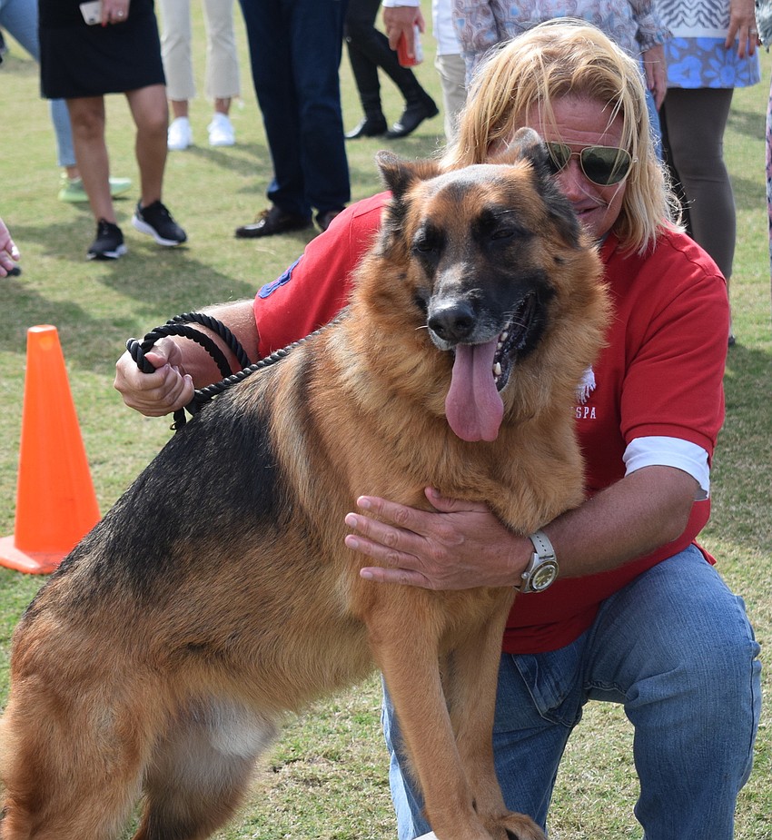 Sarasota Polo Club's Ron Trytek gives his dog Rin a big hug.