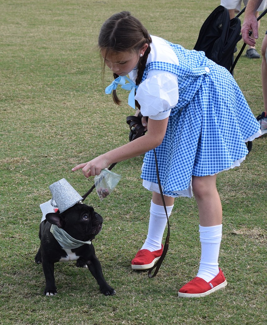 Sarasota's Olivia Pundy, dressed as Dorothy gives Willie, the Tin Man, some pre-show instructions.