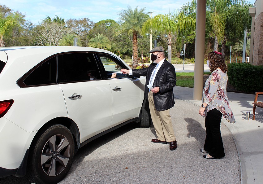 Chazzan Cliff Abramson and Rabbi Samantha Kahn perform blessings with families.