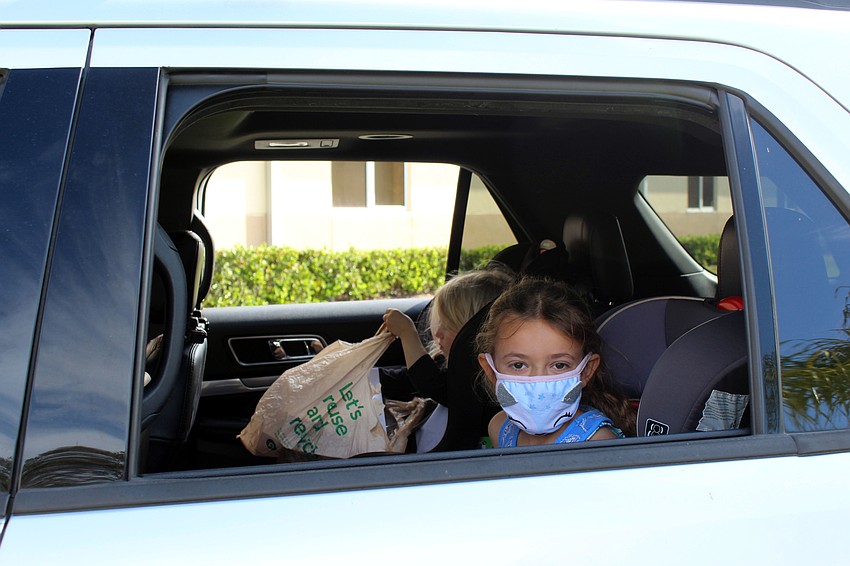Marin and Eliza Mitchell fill up their bags with crafts and snacks.
