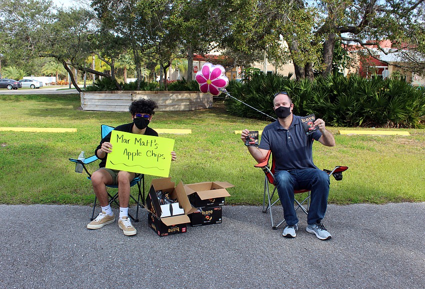 Noah Leinweber and Matt Kahn hand out apple chips.