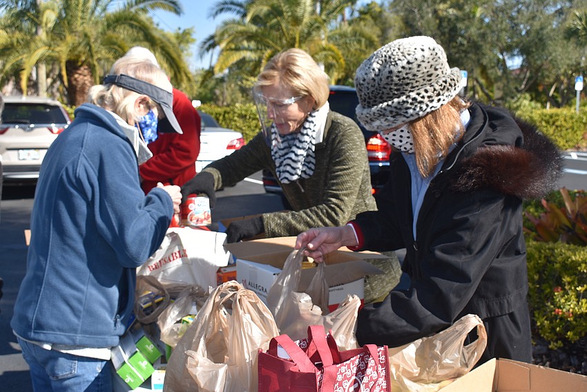 Volunteers work to sort an influx of donations.