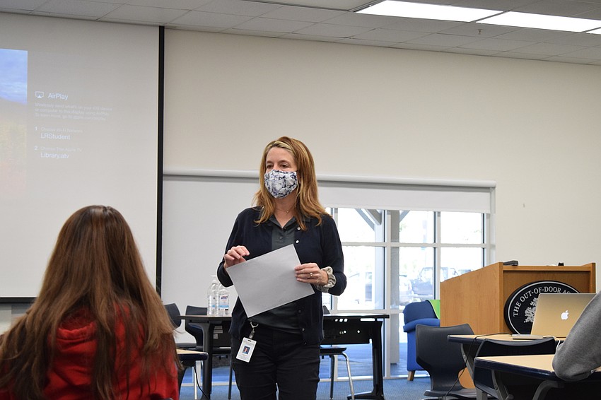 Melinda Lloyd, one of the organizers of the Blankets of Hope project at the Out-of-Door Academy, explains how the students will write a letter and tie it to a blanket to be donated to a shelter in Sarasota.