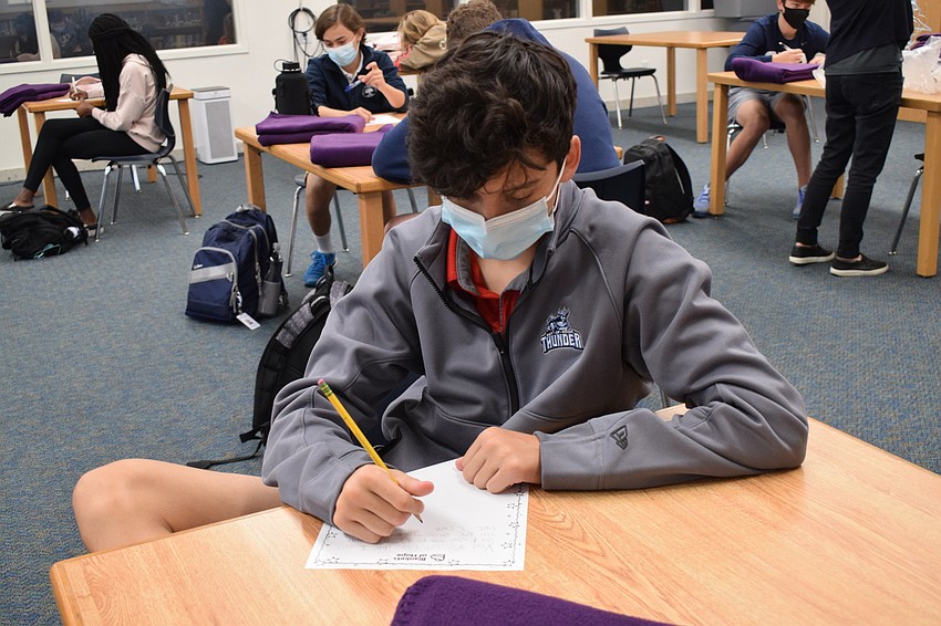 Freshman Joseph Clarke thinks about what he's going to write in his letter. 