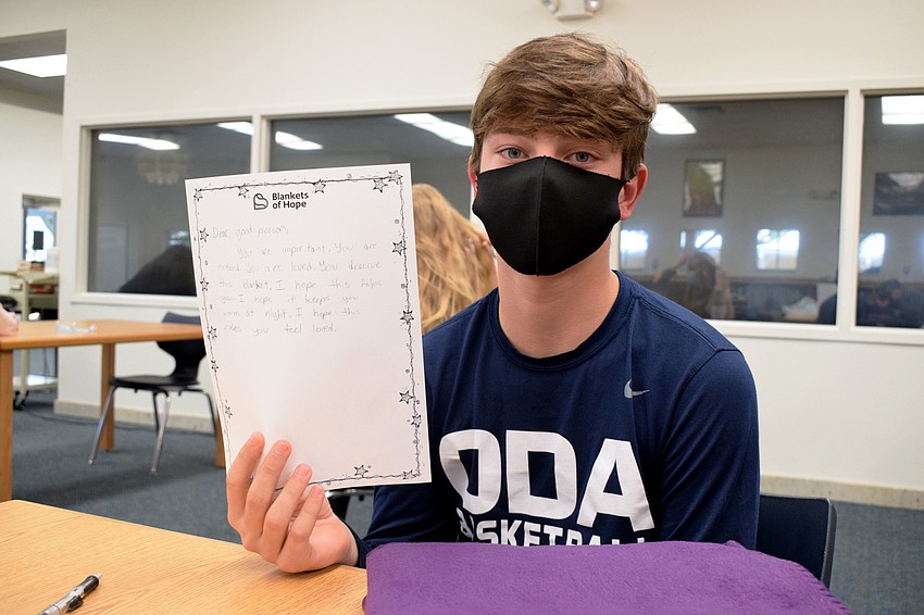 Freshman Carson Williams shares his letter before tying it to a blanket.
