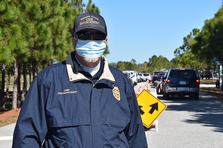 Manatee County Code Enforcement Chief Jeff Bowman works traffic control at the county's vaccine site at Tom Bennett Park.