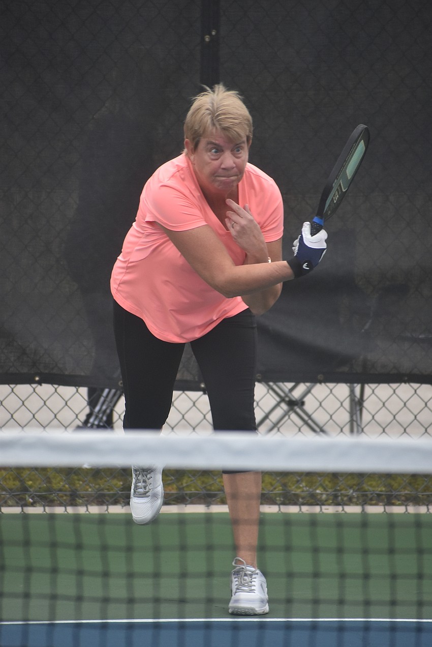 River Strand resident Cindy Cail serves the ball. She and fellow River Strand resident Deb Clawson lost their first match 15-14.