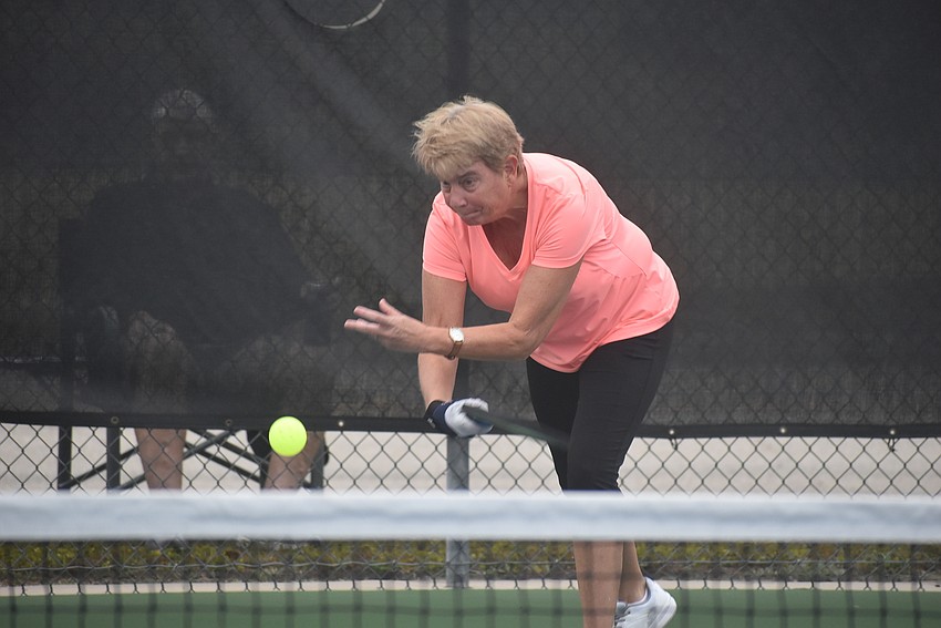 River Strand resident Cindy Cail serves the ball. She and fellow River Strand resident Deb Clawson lost their first match 15-14.