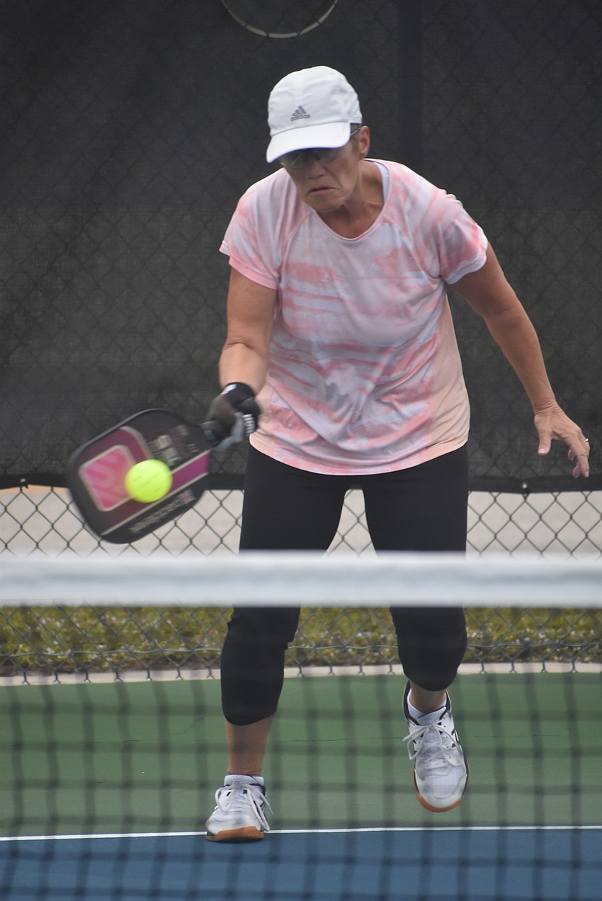 River Strand resident Deb Clawson returns the ball. She and her teammate, fellow River Strand resident Cindy Cail, have been playing pickleball for about three years.