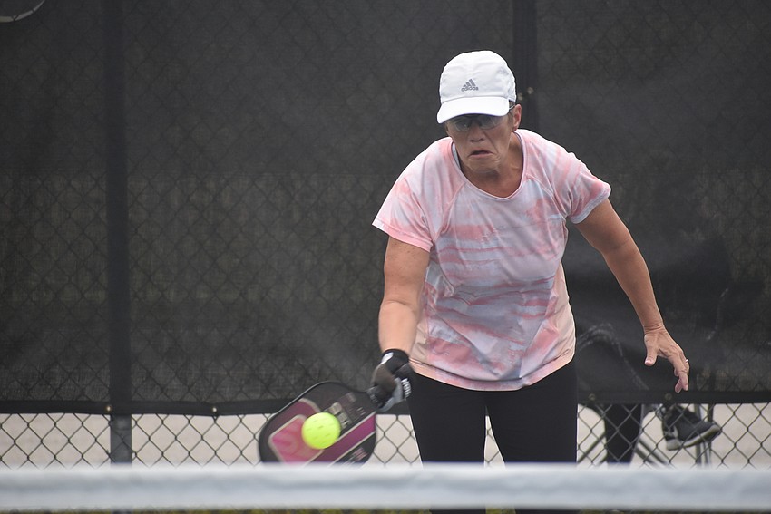 River Strand resident Deb Clawson returns the ball. She and her teammate, fellow River Strand resident Cindy Cail, have been playing pickleball for about three years.