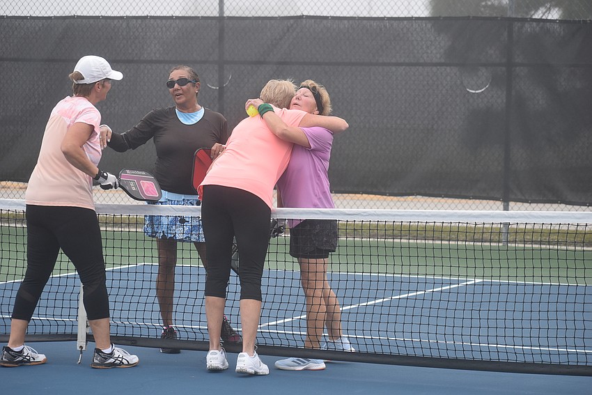 River Strand resident Deb Clawson, Stonybrook resident Jacque Marks, River Strand resident Cindy Cail and River Strand resident Roxann Viera exchange pleasantries after their match, a 15-14 victory for Marks and Viera.