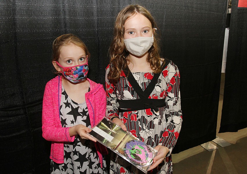 Cora and Zoey Kollett painted a CD together.