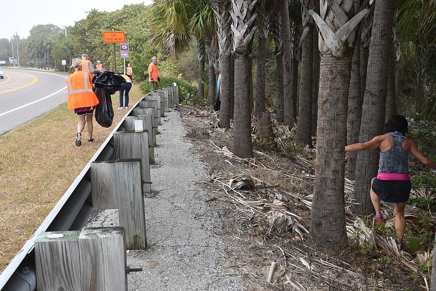 Karen Murray, right, leaps into the trees on side of the road.