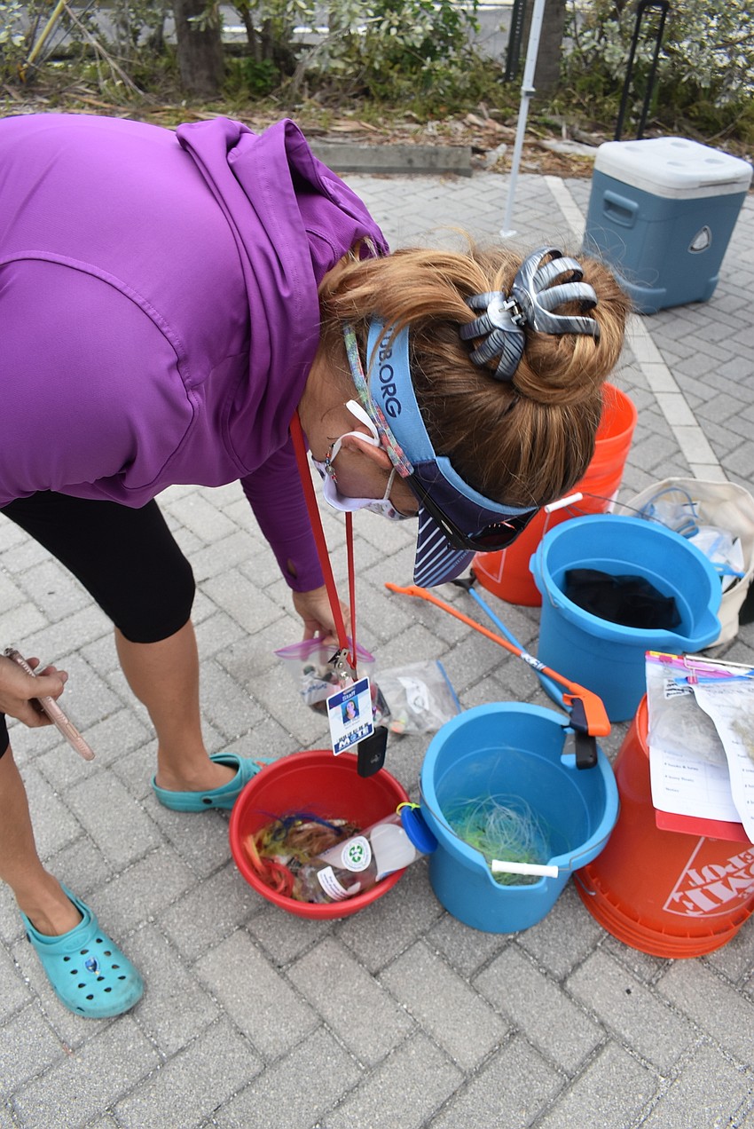 Kim Hull shows what trash can be found in the bay.