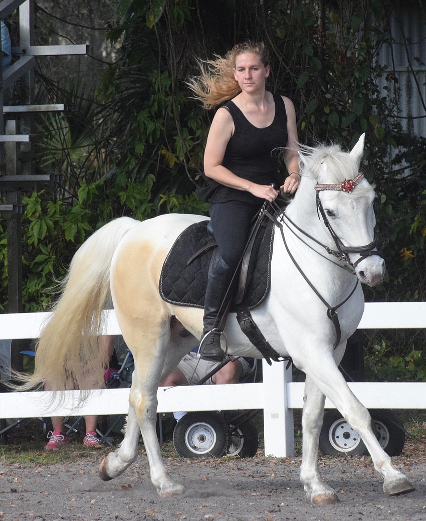 Samantha Dittman brings her horse to a run around the arena.