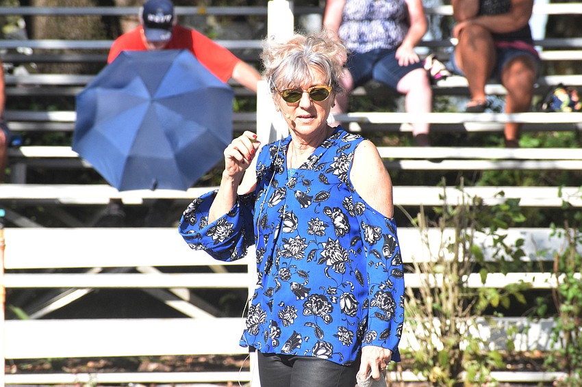 Gabriella Herrmann shares fun facts about Lipizzan stallions with the audience. It takes seven to 10 years for a Lipizzan's coat to turn from brown or black to its trademark white.