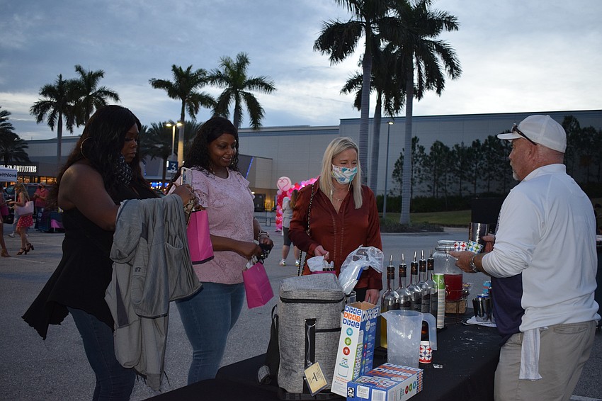 Ruskin's Tacarra Thomas and Lakewood Ranch's Cassandra Howard and Diane Sedillo get samples of drinks from Danny Wilson, a tasting room specialist at Loaded Cannon Distillery.