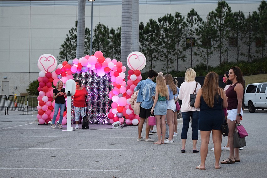 People line up to to take photos during the Gal Pal Party at the Mall at University Town Center.