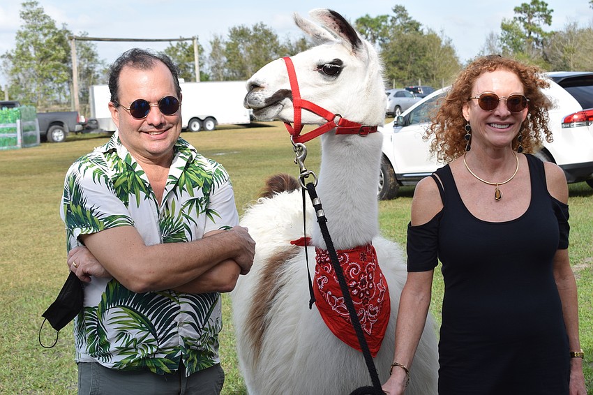 Jeff Jones, Bob the llama and Alice Jones share a moment at Bear Hugs and Kisses. Alice Jones, of Del Webb, said it was just nice to be at an event and out in nature.