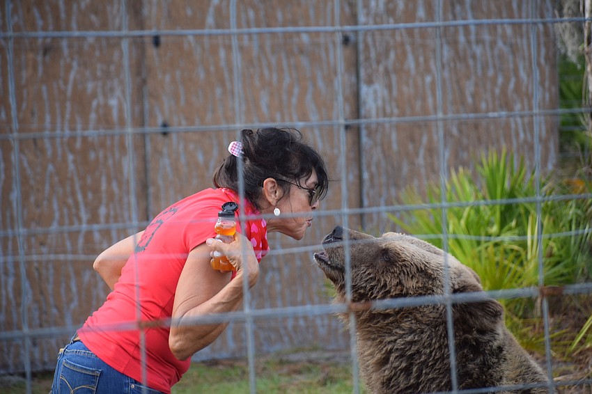 Monica Welde tells the crowd it costs about $2,000 a month to feed one of her bears.