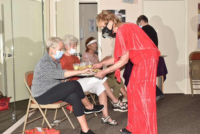 Susan Goldfarb, right, passes out champagne and chocolates to her guests.